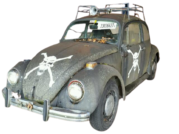 A classic Beatle car with a skull drawn on it